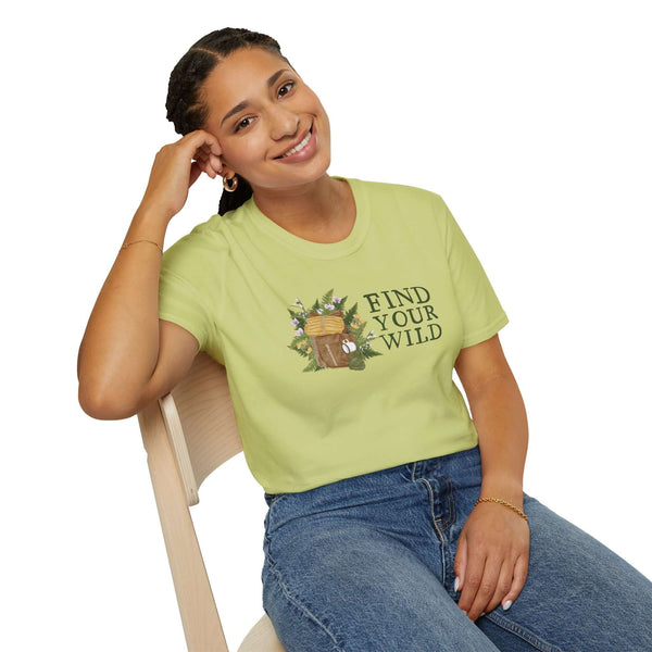 Woman wearing Find Your Wild softstyle t-shirt with watercolor backpack design, exuding outdoor adventure spirit.