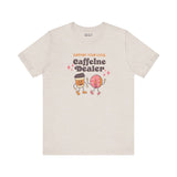 Support Your Local Caffeine Dealer coffee soft tee with playful graphic design featuring coffee cups and donuts.
