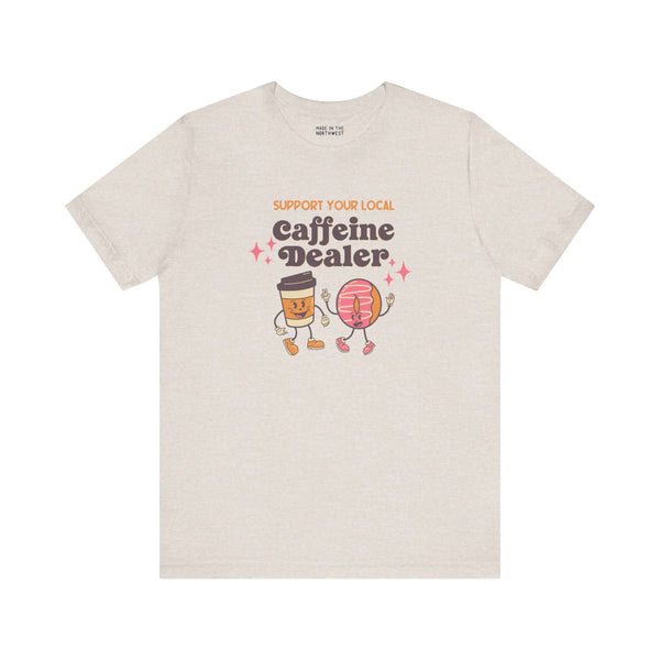 Support Your Local Caffeine Dealer coffee soft tee with playful graphic design featuring coffee cups and donuts.