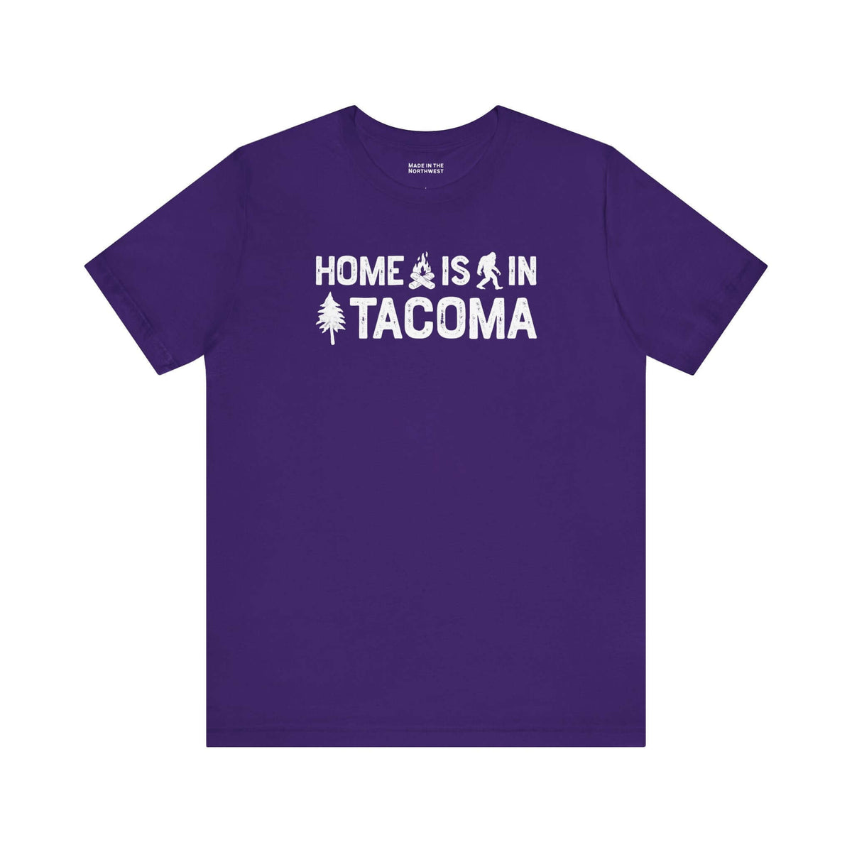 Home is in Tacoma tee on a purple shirt with Bigfoot and campfire graphic design.