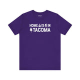 Home is in Tacoma tee on a purple shirt with Bigfoot and campfire graphic design.