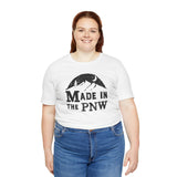 Made in the PNW T Shirt – Distressed Mountain Graphic Tee worn by a model with a smiling face.