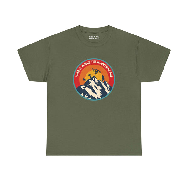 Olive green athletic tee with 'Home is Where the Mountains Are' design featuring mountains, hiking, motocross, and Bigfoot illustration.