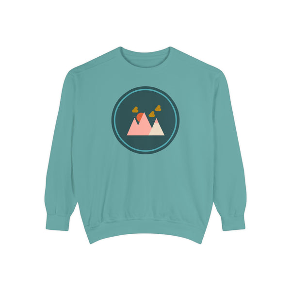 Minimalist Forest in a Northwest Style Garment Dyed Relaxed Sweatshirt in teal with mountain graphic.