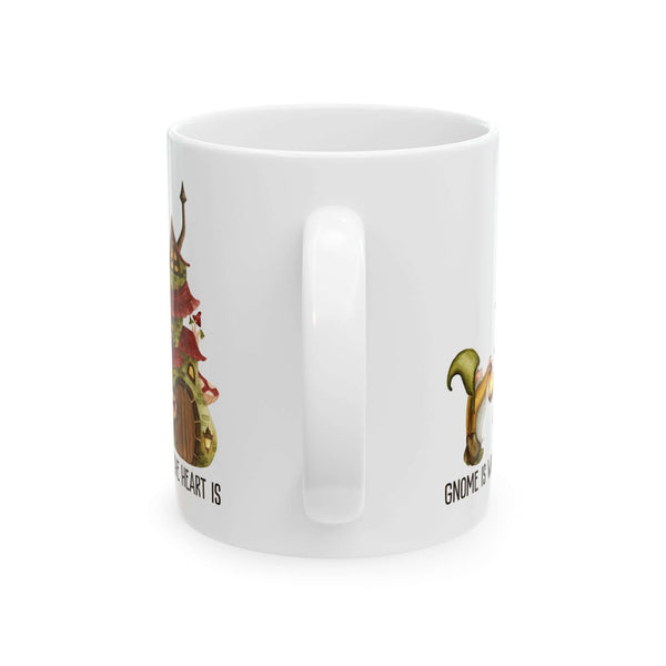 White ceramic mug featuring a gnome and a cozy mushroom house design, captioned 'Gnome Is Where The Heart Is'.