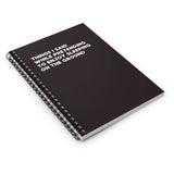 Spiral notebook with black cover and white text: 'Things I Said While Pretending to Enjoy Sleeping on the Ground'.