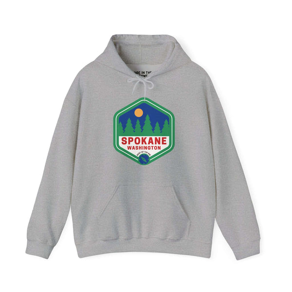 Spokane retro hoodie featuring 90s-inspired badge with trees, embodying the Pacific Northwest's spirit and outdoor beauty.