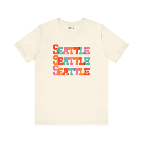 Bold Seattle Trio Tee with vibrant block-letter design celebrating the Emerald City in colorful style.