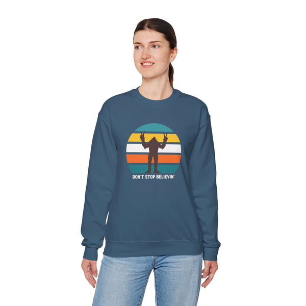 Don't Stop Believin' Bigfoot sweatshirt displaying a playful sasquatch graphic and colorful retro design.