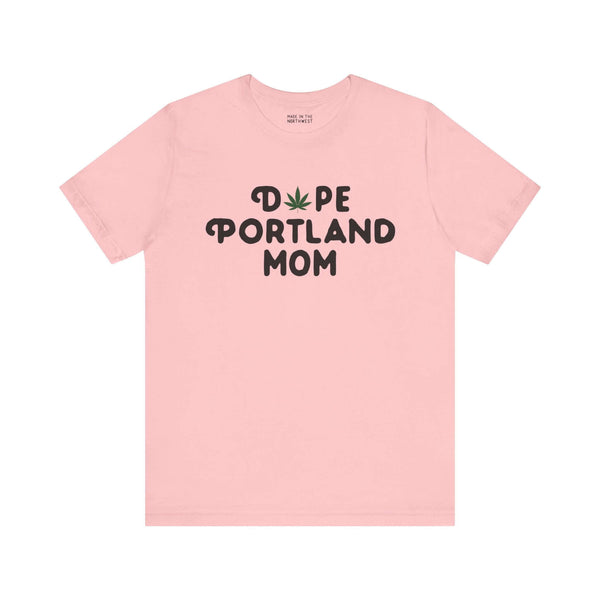 Pink "Dope Portland Mom" tee with marijuana leaf replacing the 'O', showcasing a fun and relaxed vibe for proud Portland moms.