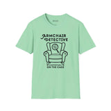 Armchair Detective T Shirt – Cozy True Crime Graphic Tee in mint green with armchair and magnifying glass design.