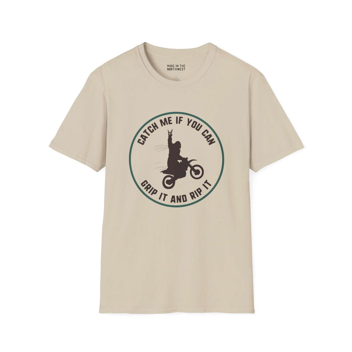 Sasquatch on a motocross bike design on beige softstyle t-shirt, perfect for riders and Bigfoot fans.