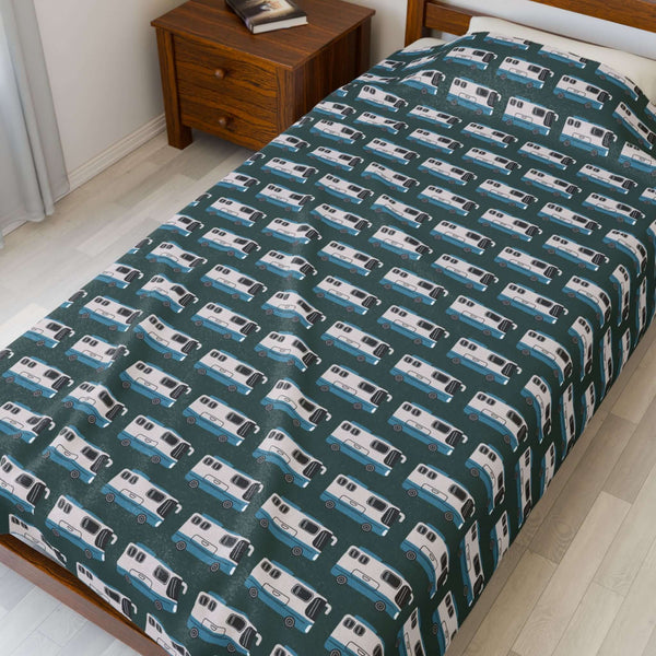 Highway Hideaway Class A Motorhome Lightweight Cozy Blanket with a repeating motorhome pattern on a bed.