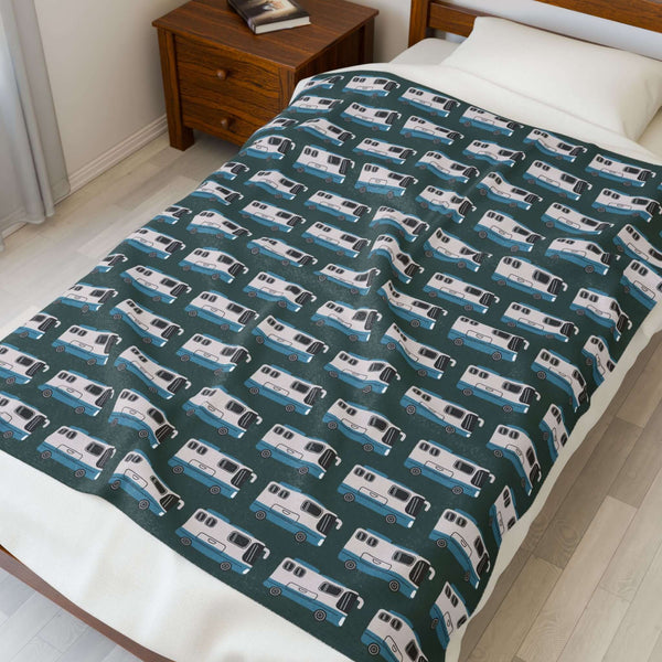 Highway Hideaway Class A Motorhome Lightweight Cozy Blanket featuring a pattern of motorhomes on a bed.