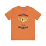 Manifest Sunshine T Shirt featuring a cheerful cartoon sun with peace signs, perfect for positive vibes every day.