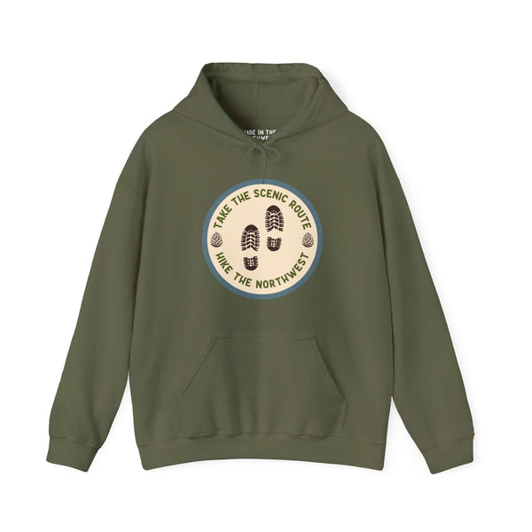 Green hoodie with "Take the Scenic Route - Hike the Northwest" design featuring hiking boot prints, ideal for outdoor enthusiasts.