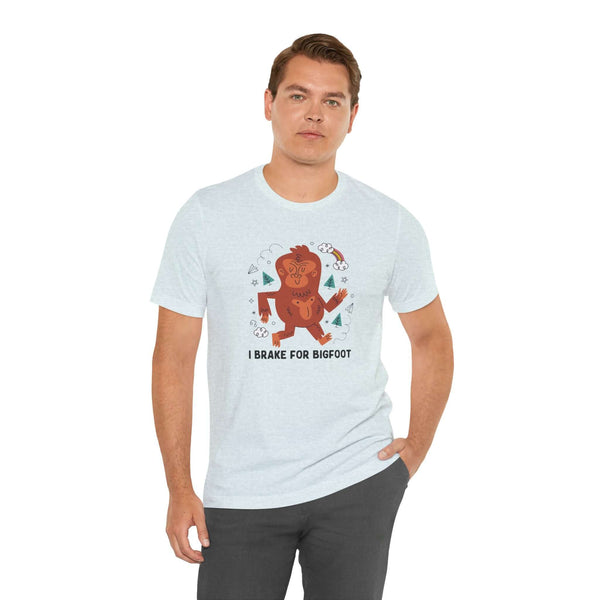 Man wearing 'I Brake for Bigfoot' premium soft tee featuring a whimsical Sasquatch graphic.