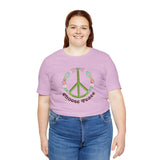 Premium soft tee featuring green peace sign and colorful flowers with 'Choose Peace' text, promoting positivity and good vibes.