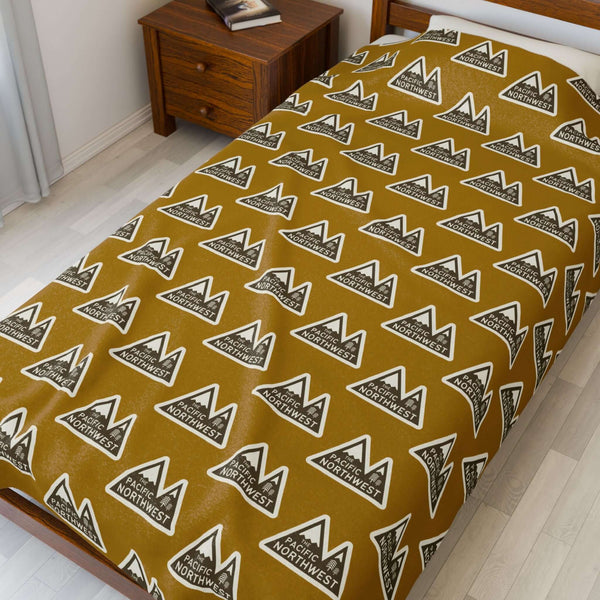 Pacific Northwest Heights Mountain Lightweight Cozy Blanket featuring a bold PNW design on a warm brown backdrop.
