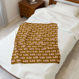 Tiny Trailer Travels RV Lightweight Cozy Blanket on a bed, featuring classic travel trailers pattern for comfort.