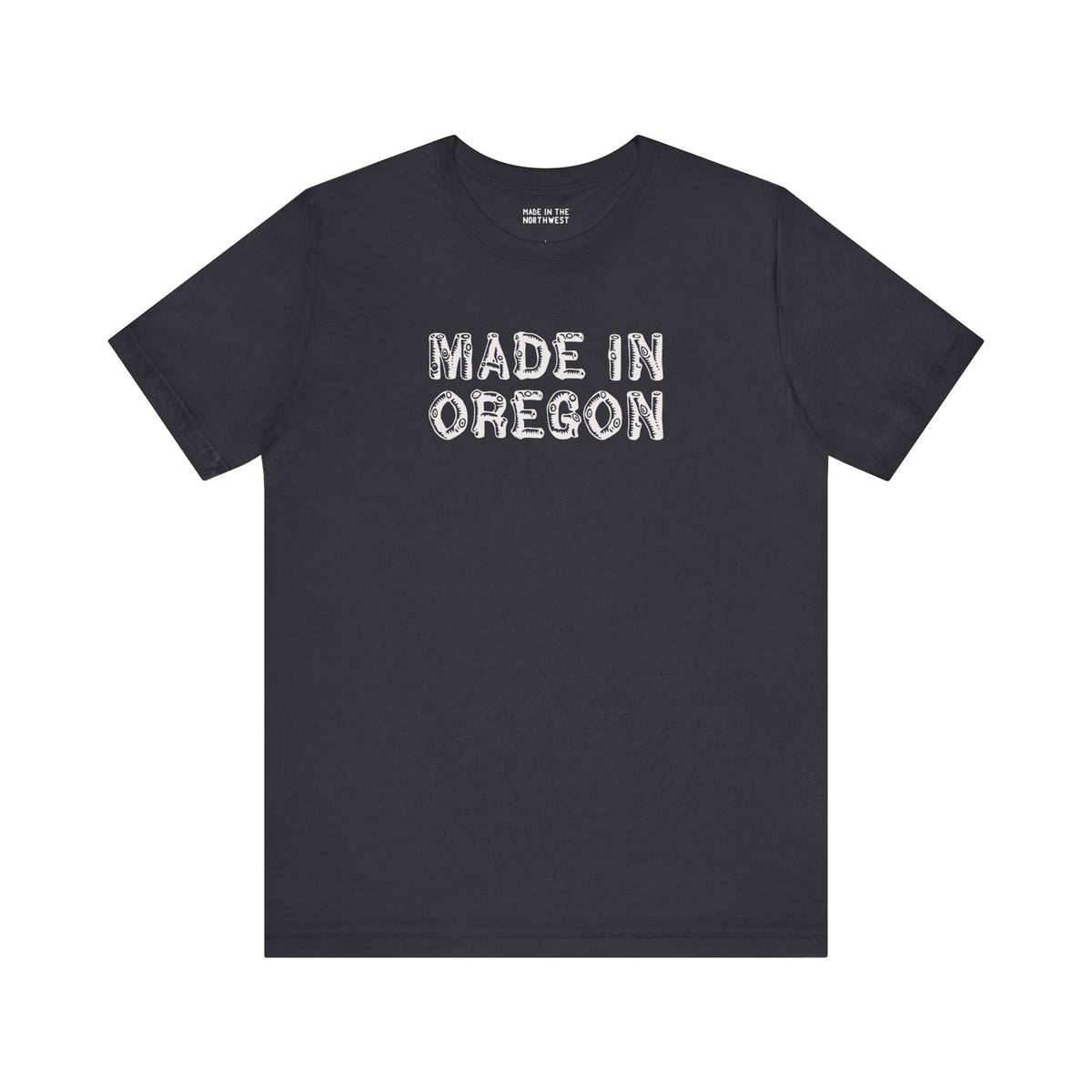 Black tee featuring 'Made in Oregon' in rustic log font, celebrating Pacific Northwest heritage and outdoor lifestyle.