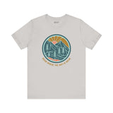 Soft hiking tee with 'Roam Where the Wifi is Weak' text, featuring a colorful forest design, perfect for nature lovers and adventure seekers.