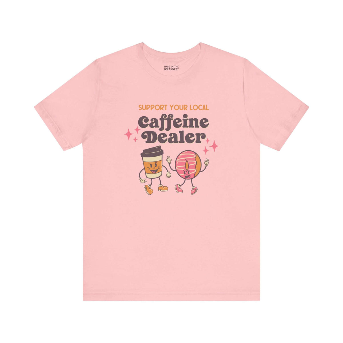 Pink soft tee with "Support Your Local Caffeine Dealer" text featuring cute coffee cup and donut graphics.