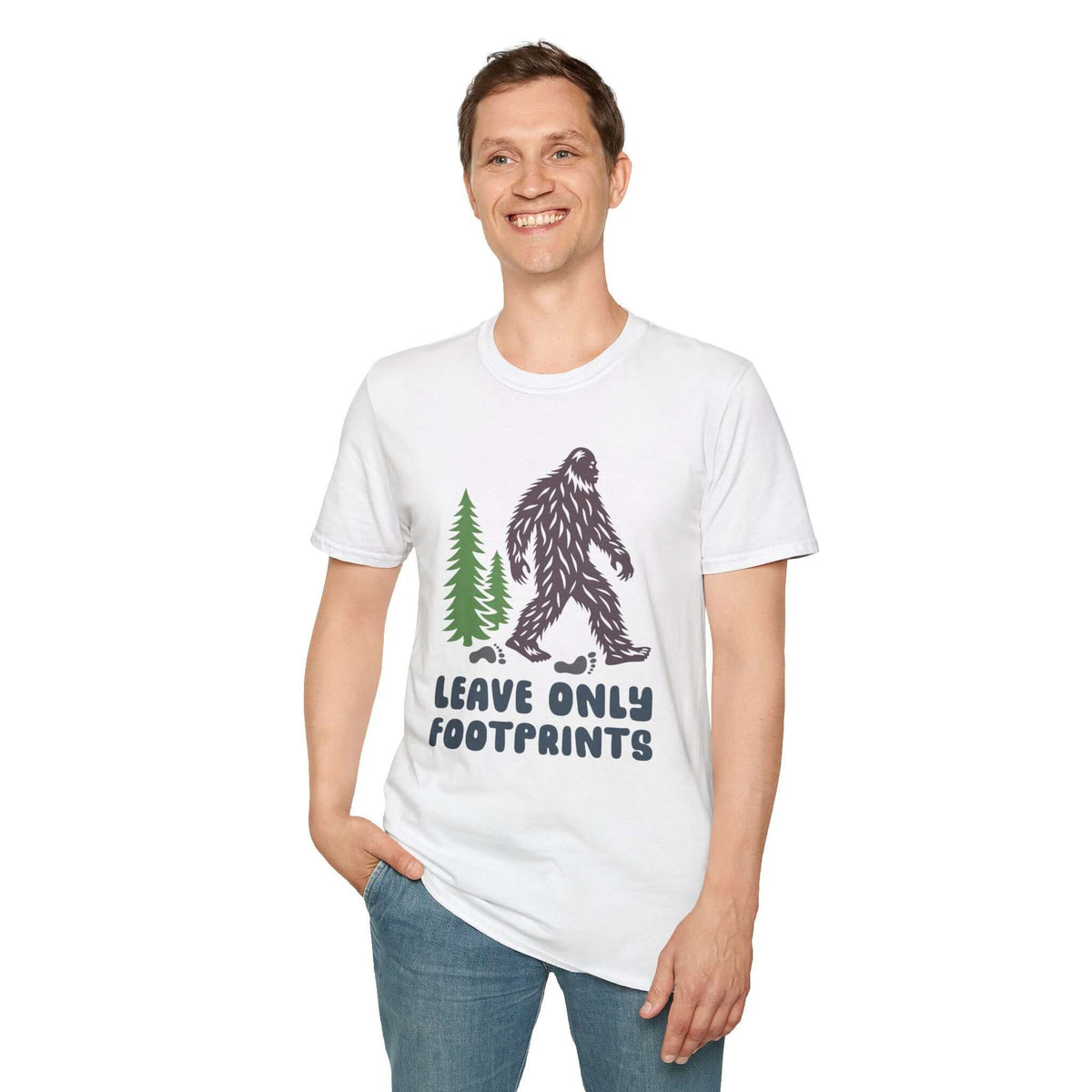 Man wearing Leave Only Footprints T Shirt featuring a Sasquatch and evergreen trees.