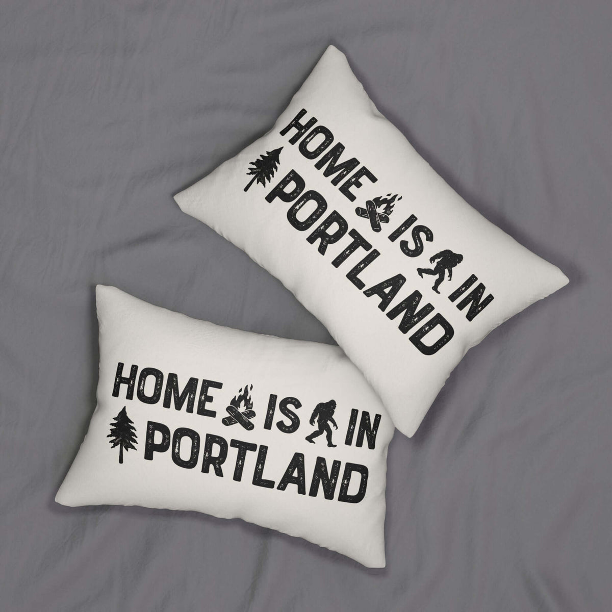 Home is in Portland Lumbar Accent Pillow with campfire and Bigfoot design on two cushions.