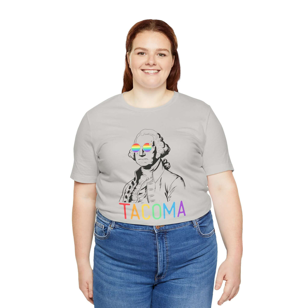 Person wearing "George's Rainbow Vision Tacoma" tee featuring rainbow glasses on George Washington and vibrant "Tacoma" text.