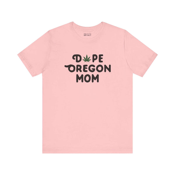 Pink "Dope Oregon Mom" tee with marijuana leaf design, highlighting Oregon pride and motherhood flair.