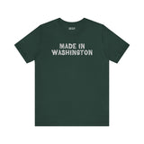 Dark green tee featuring bold 'Made in Washington' lettering in a wood log font, celebrating Pacific Northwest pride.