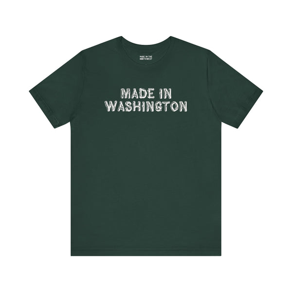 Dark green tee featuring bold 'Made in Washington' lettering in a wood log font, celebrating Pacific Northwest pride.