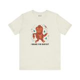 Light-colored t-shirt featuring a playful Sasquatch and the phrase 'I Brake for Bigfoot' design.