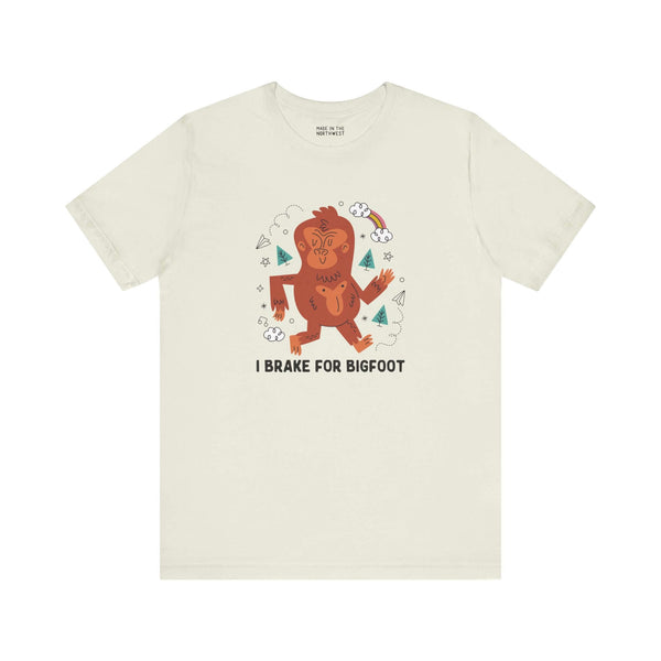 Light-colored t-shirt featuring a playful Sasquatch and the phrase 'I Brake for Bigfoot' design.