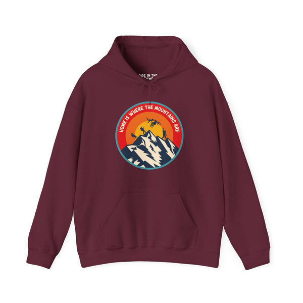 Maroon hoodie with "Home is Where the Mountains Are" design featuring mountains, hiking, motocross, and Bigfoot in a colorful circle.