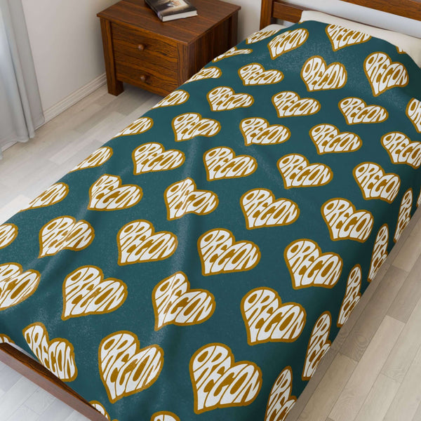 Oregon State of Mind Heart Lightweight Cozy Blanket with repeating heart pattern on a bed.