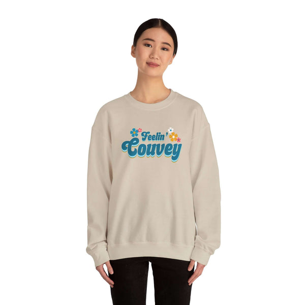 Model wearing 'Feelin' Couvey' retro sweatshirt showcasing vibrant design and cheerful colors.