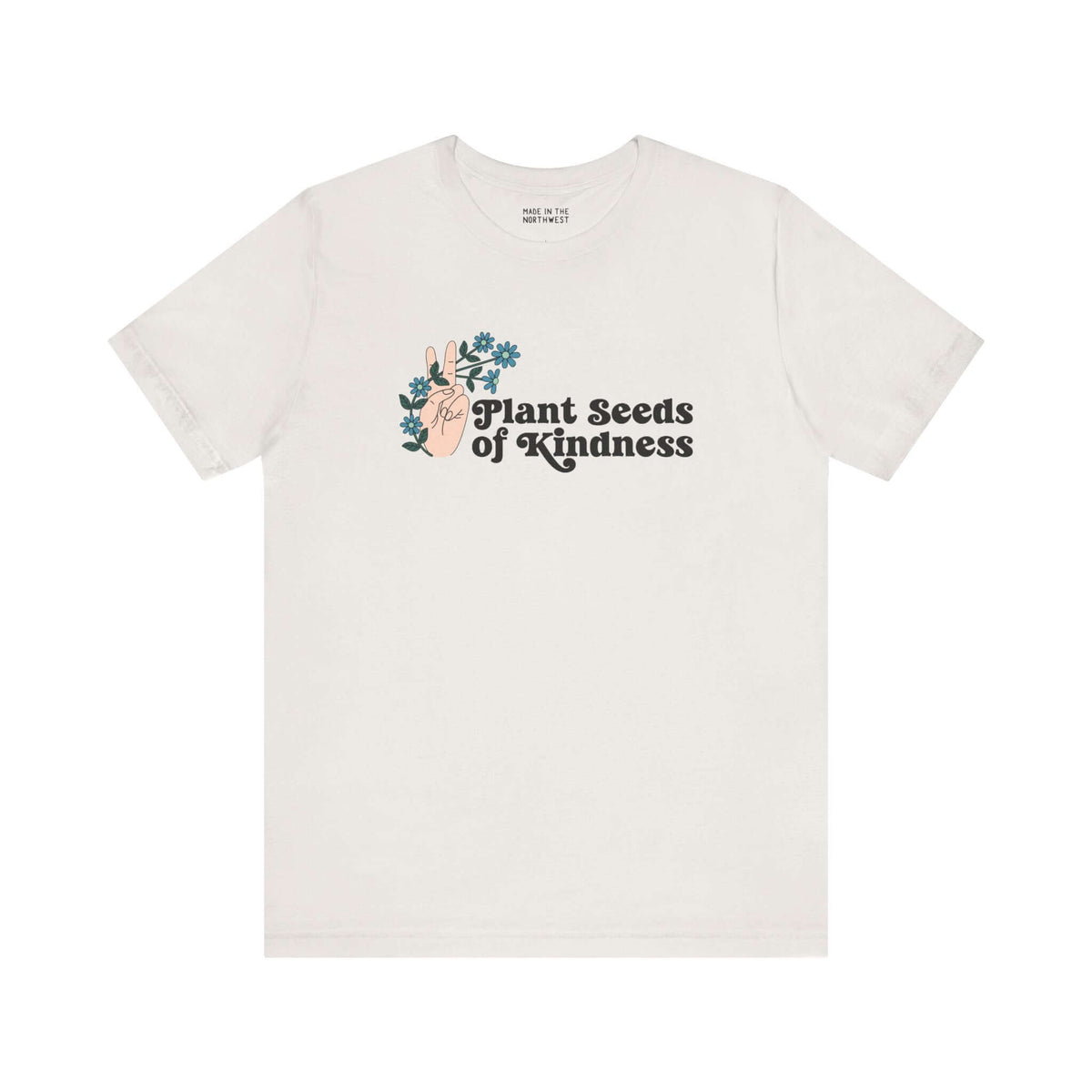 Plant Seeds of Kindness premium soft tee featuring a peace sign and blooming flowers, promoting love and positivity.