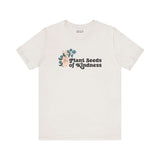 Plant Seeds of Kindness premium soft tee featuring a peace sign and blooming flowers, promoting love and positivity.