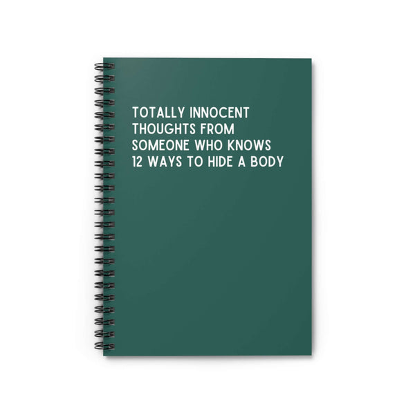 Green spiral notebook with text 'Totally Innocent Thoughts From Someone Who Knows 12 Ways to Hide a Body'.