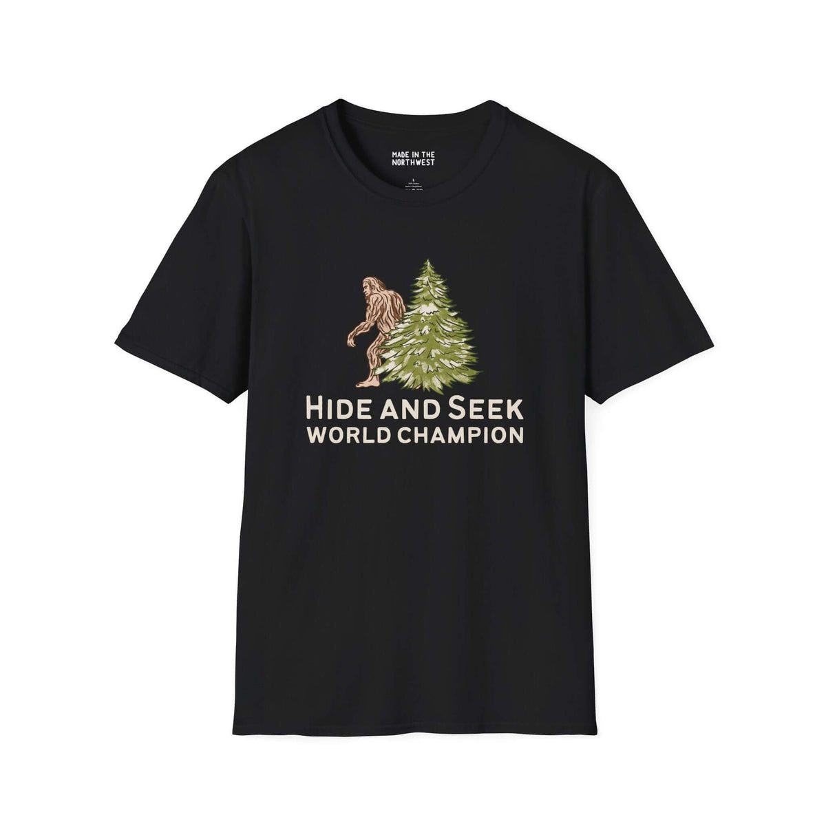 Black Hide and Seek World Champion Bigfoot T-Shirt featuring Sasquatch hiding behind a tree.