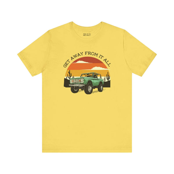 Vintage Bronco graphic tee in yellow, featuring retro adventure vibes and sunset design.