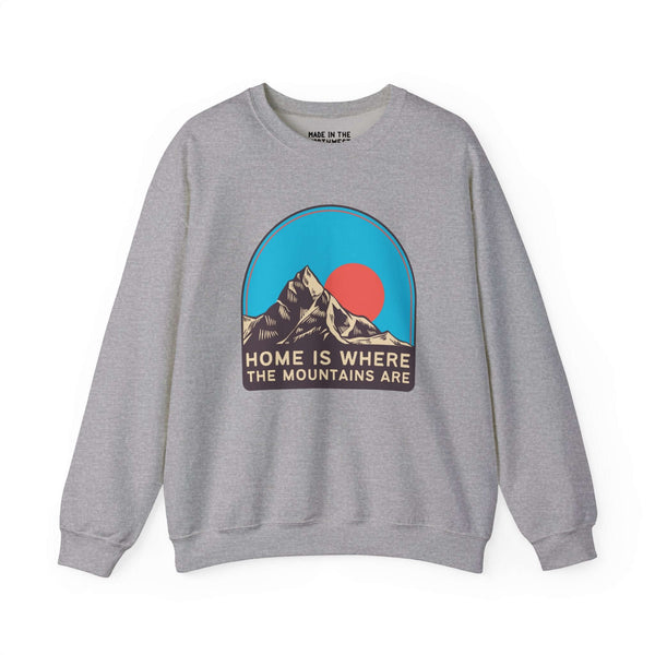 Gray sweatshirt with "Home is Where the Mountains Are" text and graphic of mountains and sky. Perfect for nature lovers and hikers.