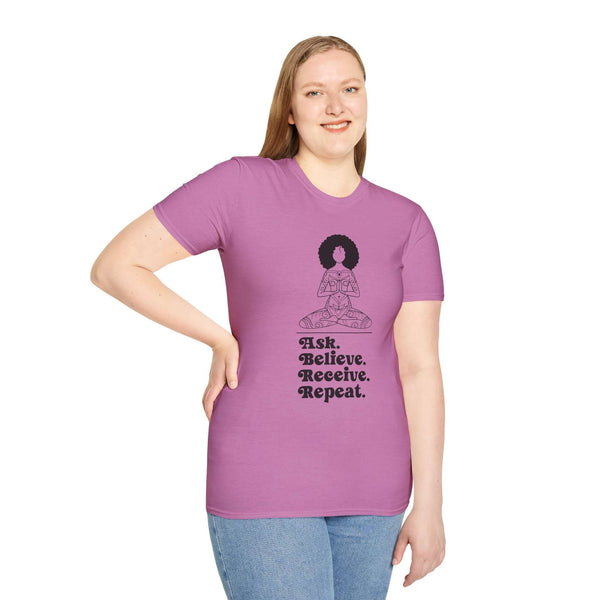 Woman wearing a pink Ask Believe Receive Repeat T-shirt with a spiritual graphic promoting mindfulness and positivity.