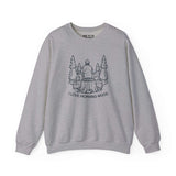 I Love Morning Wood sweatshirt featuring an outdoorsman design sitting on a log in a forest setting.