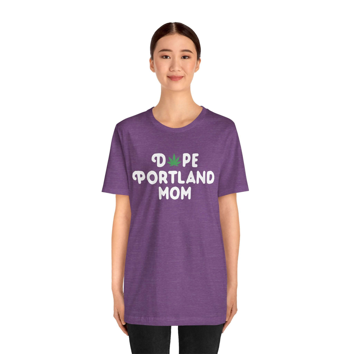 Woman wearing purple "Dope Portland Mom" tee with marijuana leaf design in 'O', showcasing unique PDX style for cool, laid-back moms.