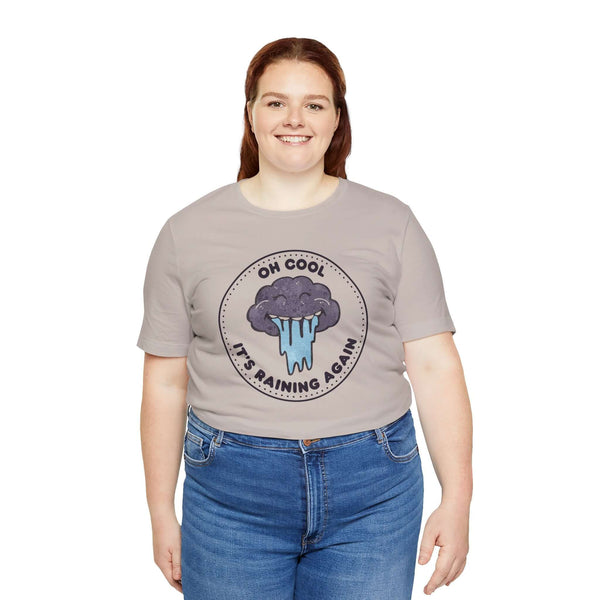 Oh Cool It's Raining Again T Shirt featuring storm cloud graphic and playful caption, perfect for casual wear.