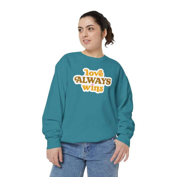 Woman wearing a love always wins sweatshirt, showcasing a cozy, warm design with a positive message.
