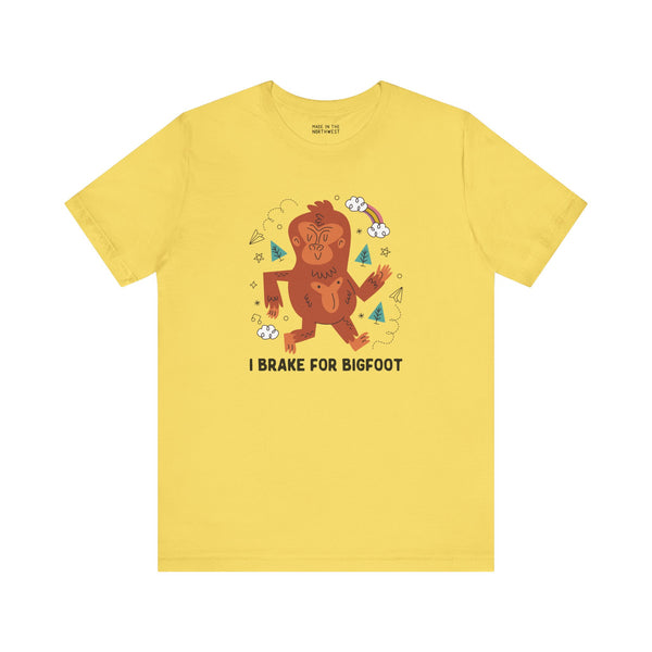 Yellow I Brake for Bigfoot tee featuring a whimsical Sasquatch graphic, perfect for folklore fans.